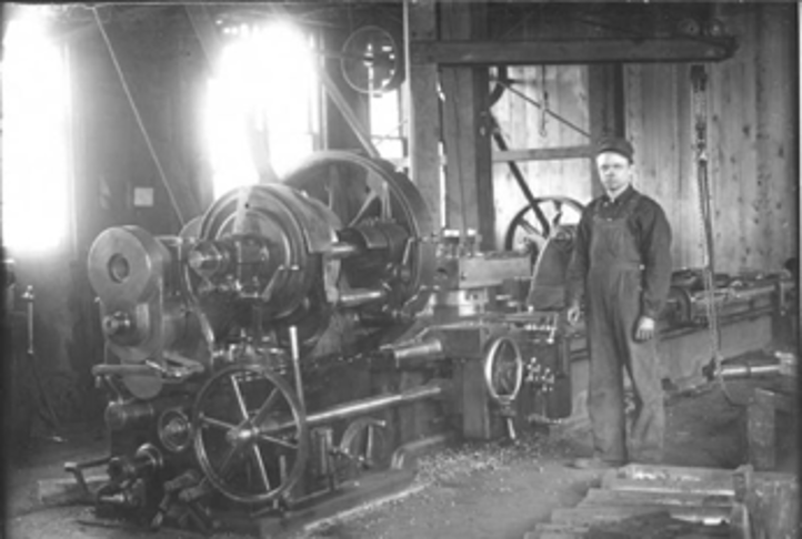 Old image of lathes that were used to work with metal were powered by steam and belts